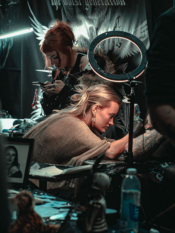One of the tattoo artists doing what she does best
